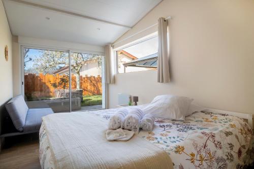 a bedroom with a bed with towels on it at Charmant pavillon bordelais (logement entier) in Saint-Médard-en-Jalles