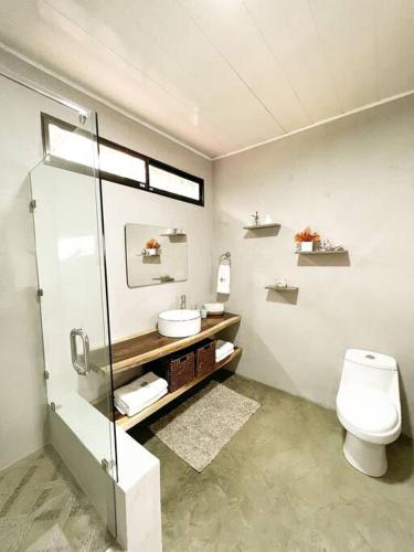 a bathroom with a shower and a toilet and a sink at Casa Boho in Quesada