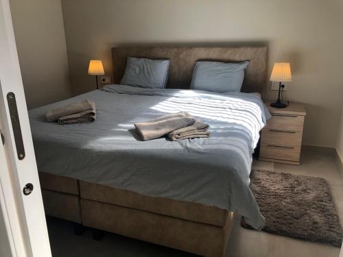 a bedroom with a large bed with two towels on it at Casa Nuevo in Mar de Cristal