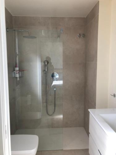 a bathroom with a shower with a toilet and a sink at Casa Nuevo in Mar de Cristal