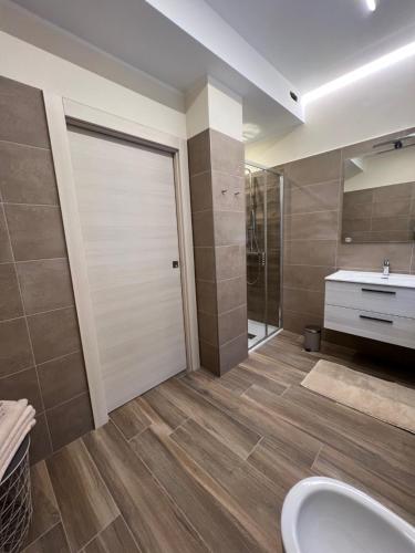 a bathroom with a shower and a toilet and a sink at Appartamento Monte in Ponte Caffaro