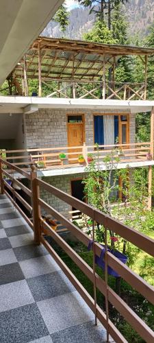 a house with a fence in front of it at The Doors Inn in Manāli
