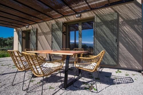 a table and chairs on the patio of a house at Villa Kalligoni in Kalligónion