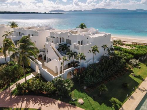 an aerial view of a white villa on the beach at Aurora Anguilla Resort & Golf Club in Rendezvous Beach