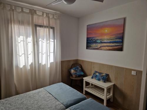 a bedroom with a bed and a window at Poema de Liria in Caleta De Fuste
