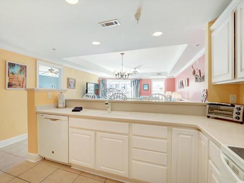 a kitchen with white cabinets and a counter top at Beachside Colony in Tybee Island