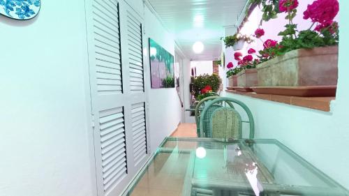 a room with a glass table and some flowers at Hotel Casa Nicola in Ischia