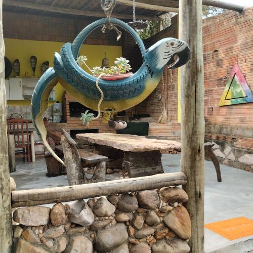 a large tire swing with a table in a room at Sítio Estrela da Manhã Hospedagem e Lazer in Palmeiras