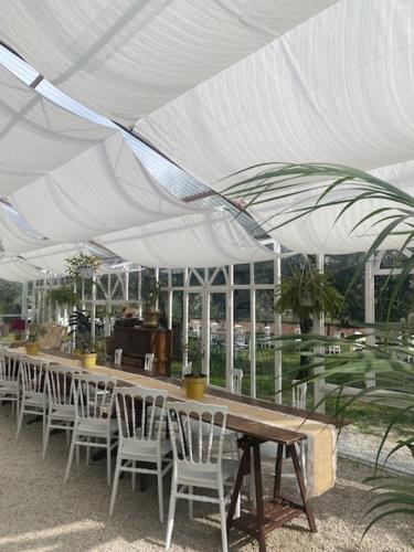 a long table and chairs under a white tent at Sotto il cielo di Toscana appartamenti in tenuta only adults no pet in Camaiore
