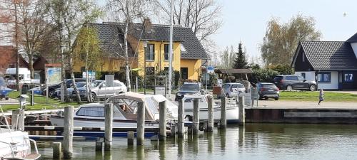 a boat docked at a dock in a marina at Ferienhaus-Bodden in Saal