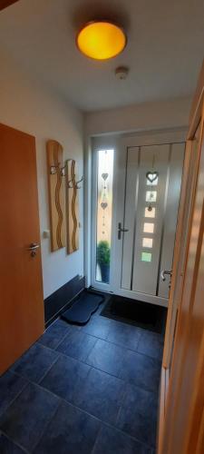 a room with a hallway with a door and a window at Ferienhaus-Bodden in Saal