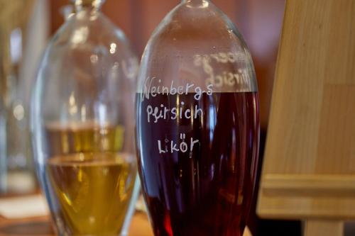 two glass bottles of wine sitting on a table at Moselhotel Weinhaus Simon `Sauna`Restaurant`ELadesäule in Wintrich