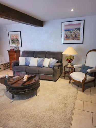 a living room with a couch and a chair at La Merlette89 in Lailly