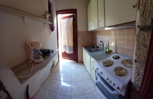 a small kitchen with a stove and a sink at Agapis Apartments in Petra