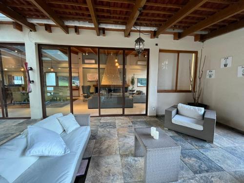 a living room with a bed and a couch at Rancho Emisajumi El Ajusco in Mexico City