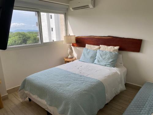a bedroom with a bed with a large window at Playa Caracol Chame in Chame