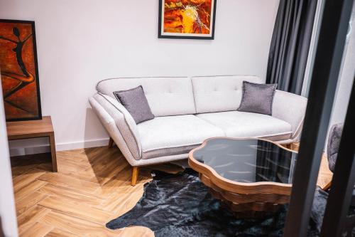 a living room with a couch and a coffee table at Giardino Lux Apartments in Ulcinj