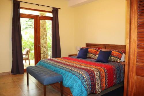 a bedroom with a bed and a chair and a window at Secluded Ocean Front Overlooking the Marina in San Carlos