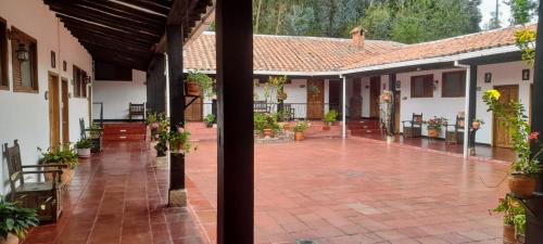 a courtyard of a house with potted plants at Hotel MAXIRUMA - Villa TAMAUKA in Iza