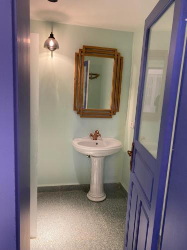 a bathroom with a sink and a mirror at Dar Alice in Soûr
