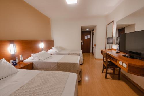 Ένα ή περισσότερα κρεβάτια σε δωμάτιο στο Hotel Caiuá