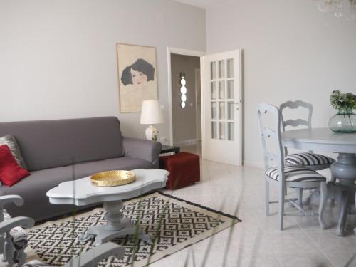 a living room with a couch and a table at Domus Tilla in Piombino