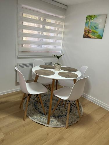 a table and chairs in a room with a window at Lily in Belgrade