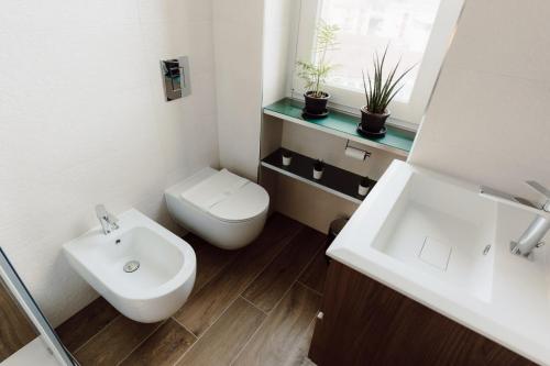 a bathroom with a white toilet and a sink at Vittoria Suite in Campobasso