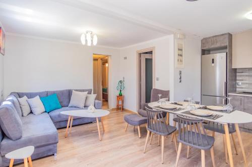 a living room with a couch and a table and chairs at Dion apartment in Lygia