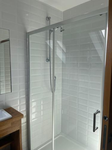 a shower with a glass door in a bathroom at Corsee House in Nairn