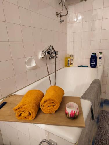 a bathroom with a bath tub with towels on a wooden tray at Apartman Tanja Trebinje in Hrupjela