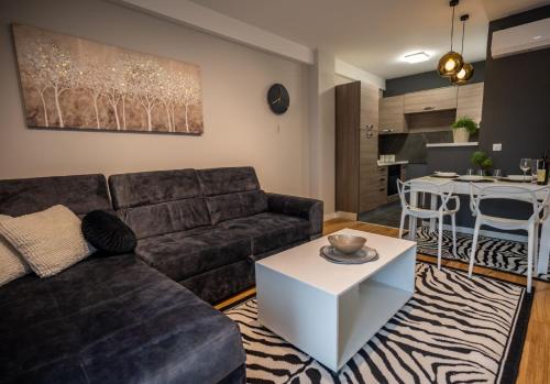 a living room with a couch and a table at Apartment Leona in Kraljevo