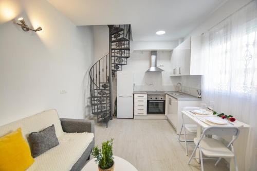 a living room and kitchen with a couch and a table at Soul Home Alhaurín el Grande in Alhaurín el Grande