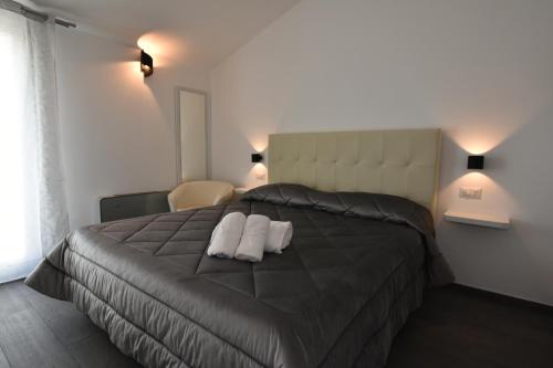 a bedroom with a bed with two pillows on it at CAVOUR ROOMS in Olbia