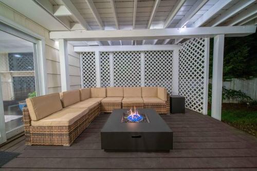 a patio with a couch and a fire pit at New Beach Home near Stamford Downtown/Shippan in Stamford