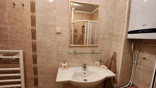 a bathroom with a sink and a mirror at Nevena Summer Apartment by Santa Marina Sozopol in Sozopol