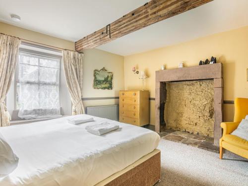 a bedroom with a bed and a fireplace at The Farmhouse in Bakewell