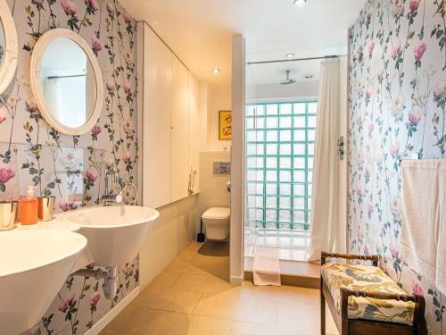 a bathroom with a tub and a sink and a toilet at The Farmhouse in Bakewell
