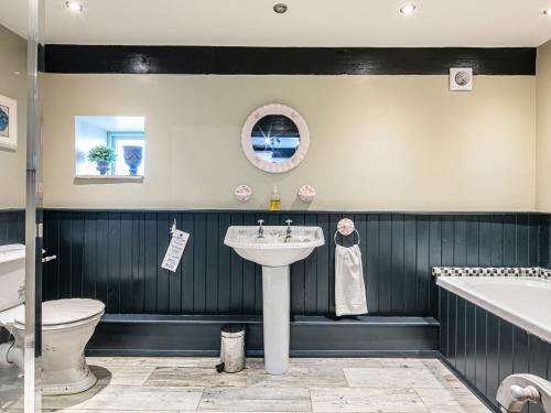 a bathroom with a sink and a tub and a toilet at Bramble in Bakewell