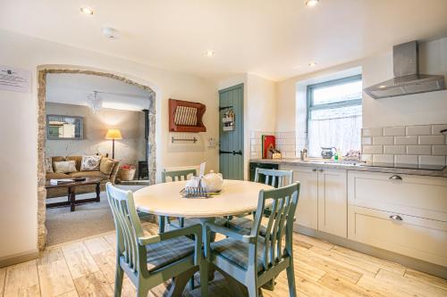 a kitchen and dining room with a table and chairs at Fruitpip in Bakewell
