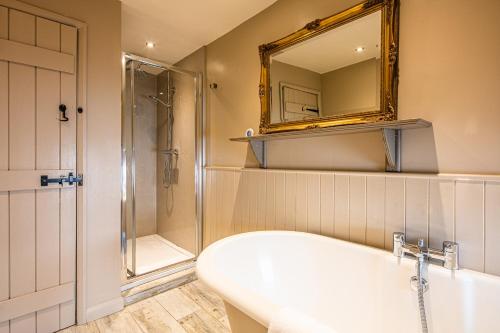 a bathroom with a sink and a shower and a mirror at Fruitpip in Bakewell