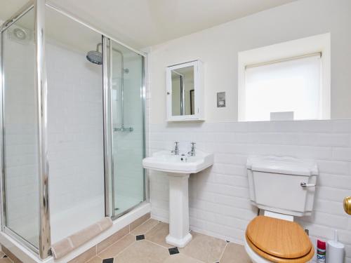 a bathroom with a toilet and a sink and a shower at North Lodge in Bakewell