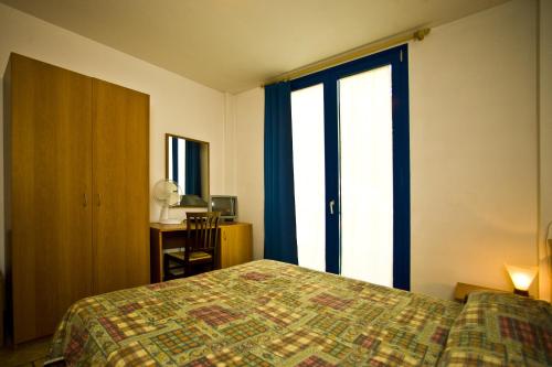 מיטה או מיטות בחדר ב-Hotel Il Canneto