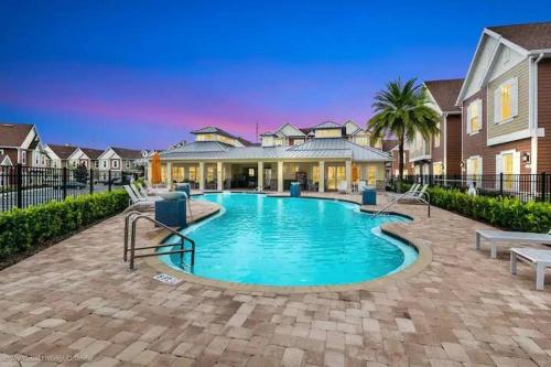 a swimming pool in front of a house at 5 Suites DREAM House 5 min to Disney in Orlando