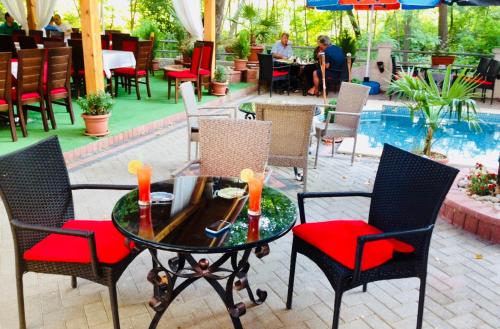 a patio with a table and chairs and a pool at Villa Bella Boutique Hotel in Kavadarci