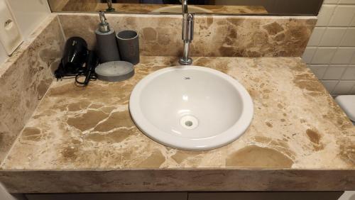 a bathroom counter with a sink in the middle of it at COBERTURA VISTA MAR in João Pessoa