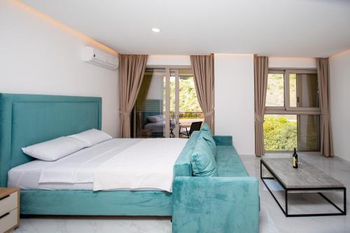 1 dormitorio con 1 cama y 1 sofá azul en Aura Tower aparments by In Property, en Rafailovici