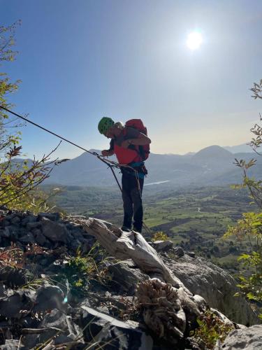 a man is standing on a rock with a pole at TibetiAmo in Castelsaraceno