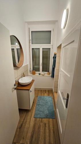 ein Bad mit einem Waschbecken und einem Spiegel in der Unterkunft surf.Lend in Graz