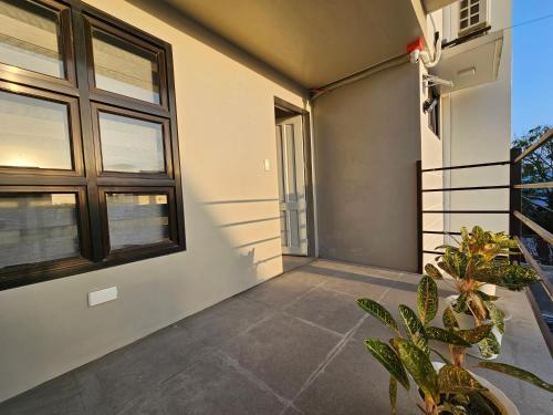 a balcony of a house with windows and a plant at Spacious 5-bedroom, 4-bath townhouse in Legazpi City in Legazpi